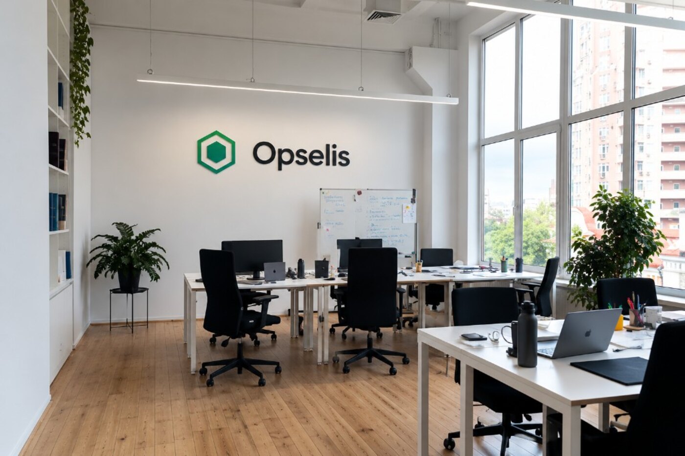 Opselis office, logo on the wall and workstations